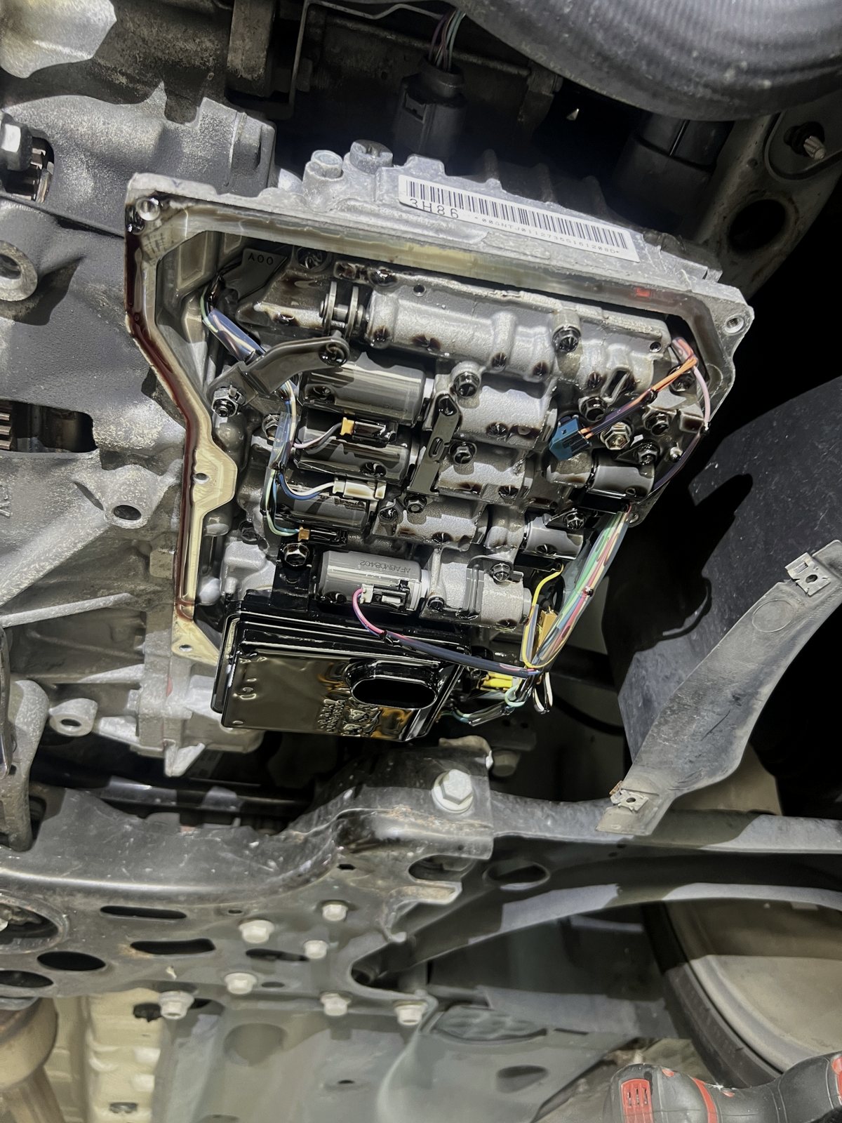 Dual-clutch transmission mechatronic unit exposed during repair